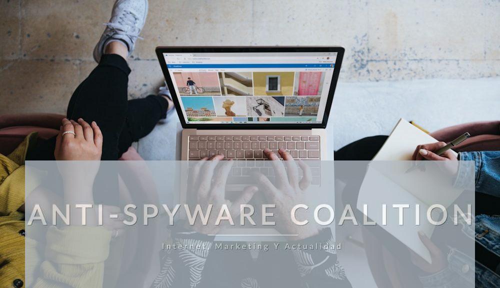 person using microsoft surface laptop on lap with two other people