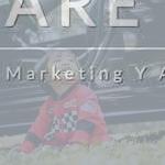boy sitting on grass in front of parked car